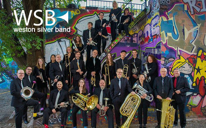 Photo of Weston Silver Band in front of graffiti painted wall.