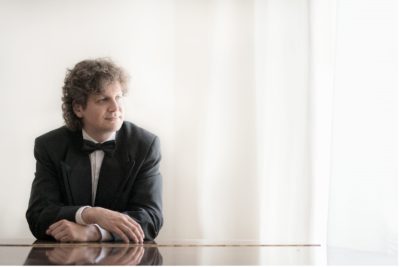 Photogaph of Daniel Vnukowski, wearing a suit looking into the distance.